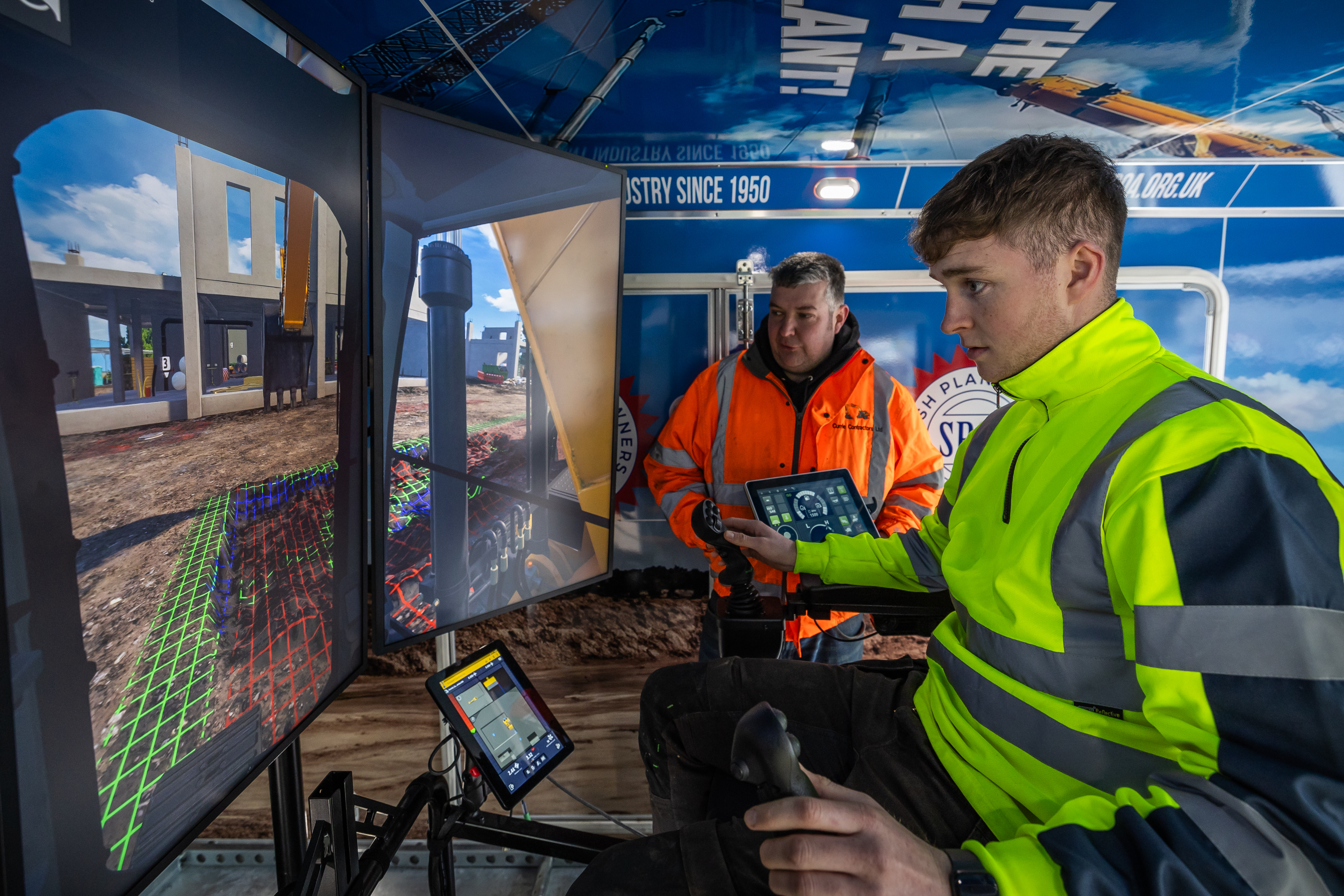 James Currie with plant operator using simulator at Moray West Substation construction site2.jpg